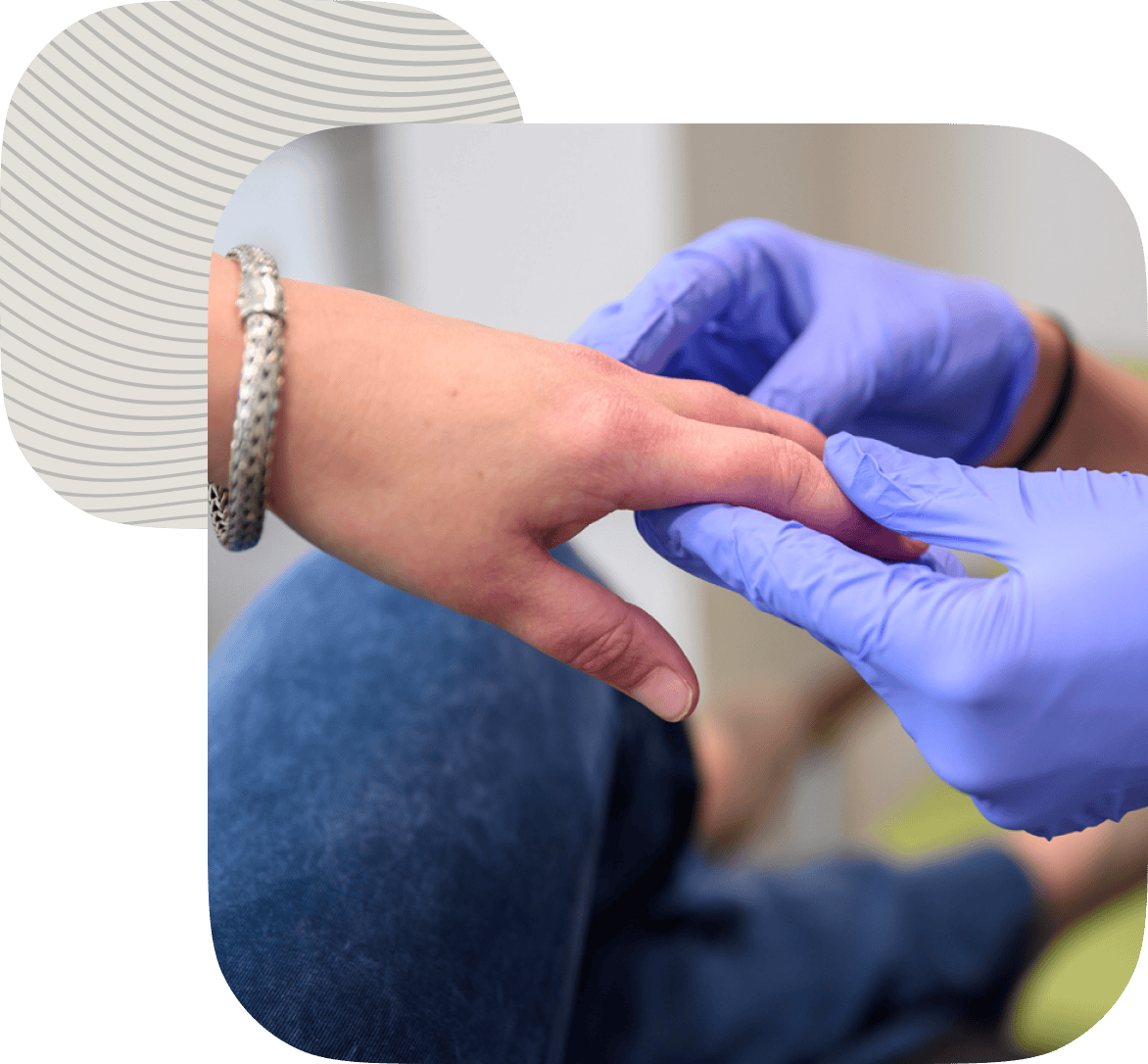 True Dermatology medical provider looks at a woman's hands during an appointment