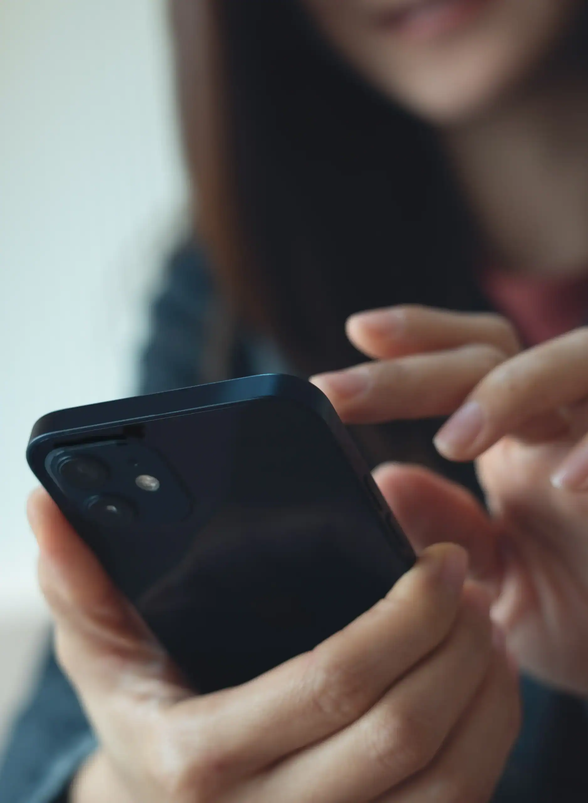 Woman using a mobile phone to download an app